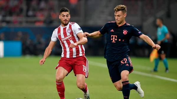 Olympiakos' Greek midfielder Giorgios Masouras (L) fights for the ball with Bayern Munich's German midfielder Joshua Kimmich during the UEFA Champions League group B football match between Olympiacos FC and FC Bayern Munchen on October 22, 2019 at the Georgios Karaiskakis stadium in Piraeus near Athens, on October 22, 2019. (Photo by LOUISA GOULIAMAKI / AFP) (Photo by LOUISA GOULIAMAKI/AFP via Getty Images)