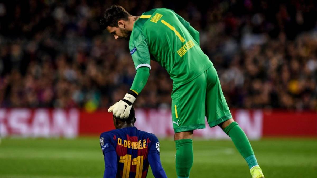 Barcelona's French forward Ousmane Dembele (L) is conforted by Dortmund's Swiss goalkeeper Roman Buerki after an injury during the UEFA Champions League Group F football match between FC Barcelona and Borussia Dortmund at the Camp Nou stadium in Barcelona, on November 27, 2019. (Photo by Josep LAGO / AFP) (Photo by JOSEP LAGO/AFP via Getty Images)