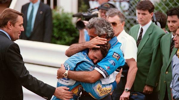 Benetton-Ford's team manager Flavio Briatore (R) hugs German driver Michael Schumacher after his victory in the Monaco Formula One Grand Prix on May 15, 1994. (Photo by Christophe SIMON / AFP)        (Photo credit should read CHRISTOPHE SIMON/AFP via Getty Images)
