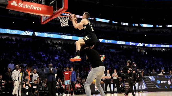 CHICAGO, ILLINOIS - FEBRUARY 15: Pat Connaughton #24 of the Milwaukee Bucks dunks the ball over Giannis Antetokounmpo in the 2020 NBA All-Star - AT&T Slam Dunk Contest during State Farm All-Star Saturday Night at the United Center on February 15, 2020 in Chicago, Illinois. NOTE TO USER: User expressly acknowledges and agrees that, by downloading and or using this photograph, User is consenting to the terms and conditions of the Getty Images License Agreement. (Photo by Jonathan Daniel/Getty Images)