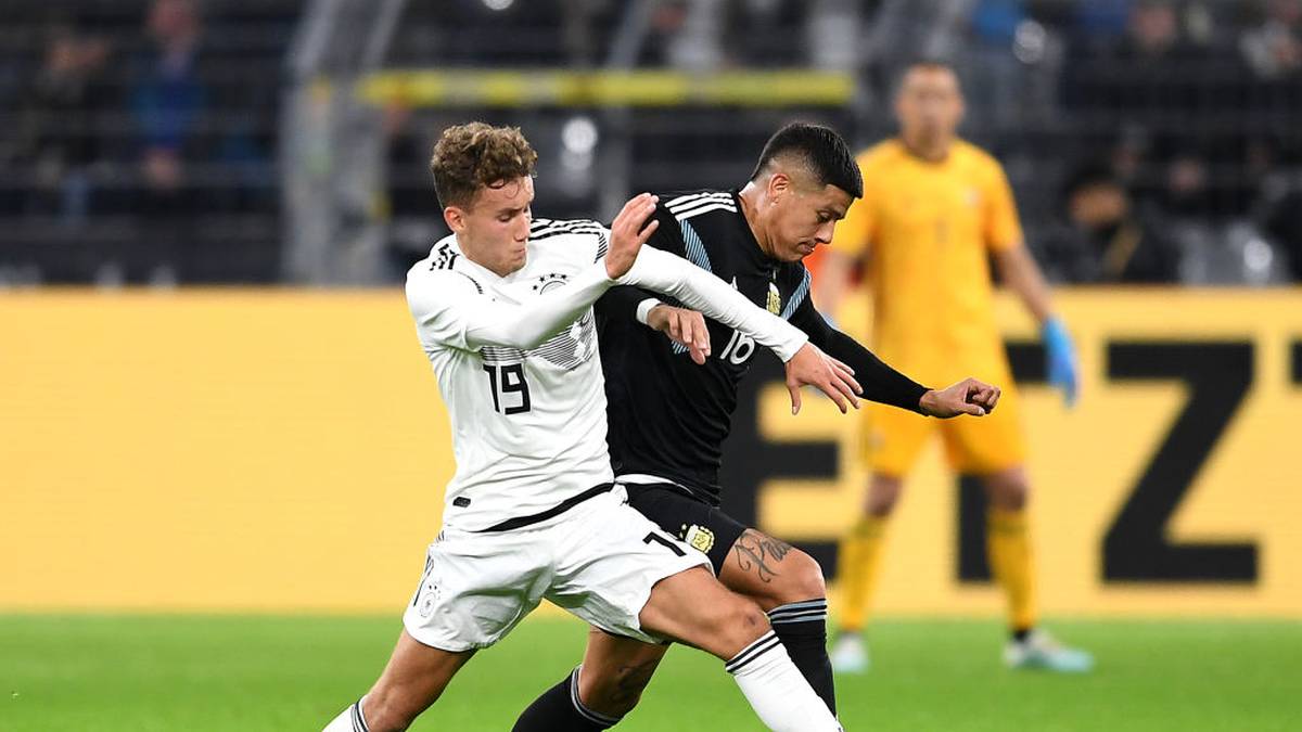 DORTMUND, GERMANY - OCTOBER 09:  Luca Waldschmidt of Germany is tackled by  Marcos Rojo of Argentina during the International Friendly between Germany and Argentina at Signal Iduna Park on October 09, 2019 in Dortmund, Germany. (Photo by Jörg Schüler/Bongarts/Getty Images)