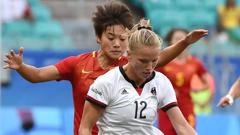Tabea Kemme (front) of Germany vies for the ball with Shuang Wang of China during their Rio 2016 Olympic Games women's quarter-final football match at the Arena Fonte Nova Stadium in Salvador, Brazil, on August 12, 2016. / AFP / NELSON ALMEIDA        (Photo credit should read NELSON ALMEIDA/AFP via Getty Images)