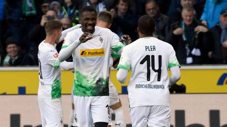 Moenchengladbach's French forward Marcus Thuram and Moenchengladbach's French forward Alassane Plea (R) celebrate celebrate scoring during the German first division Bundesliga football match Borussia Moenchengladbach v Werder Bremen in Moenchengladbach, western Germany on November 10, 2019. (Photo by INA FASSBENDER / AFP) / RESTRICTIONS: DURING MATCH TIME: DFL RULES TO LIMIT THE ONLINE USAGE TO 15 PICTURES PER MATCH AND FORBID IMAGE SEQUENCES TO SIMULATE VIDEO. == RESTRICTED TO EDITORIAL USE == FOR FURTHER QUERIES PLEASE CONTACT DFL DIRECTLY AT + 49 69 650050 (Photo by INA FASSBENDER/AFP via Getty Images)