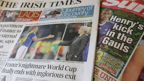 The front pages of some of the Irish daily newspapers referring to France's exit from the 2010 World Cup are pictured in Strangford, Northern Ireland, on June 23, 2010. Irish newspapers revelled on Wednesday in France's humiliating exit from the World Cup describing it as poetic justice for Thierry Henry's handball which kept Ireland from going to South Africa. AFP PHOTO/Peter Muhly (Photo credit should read PETER MUHLY/AFP via Getty Images)