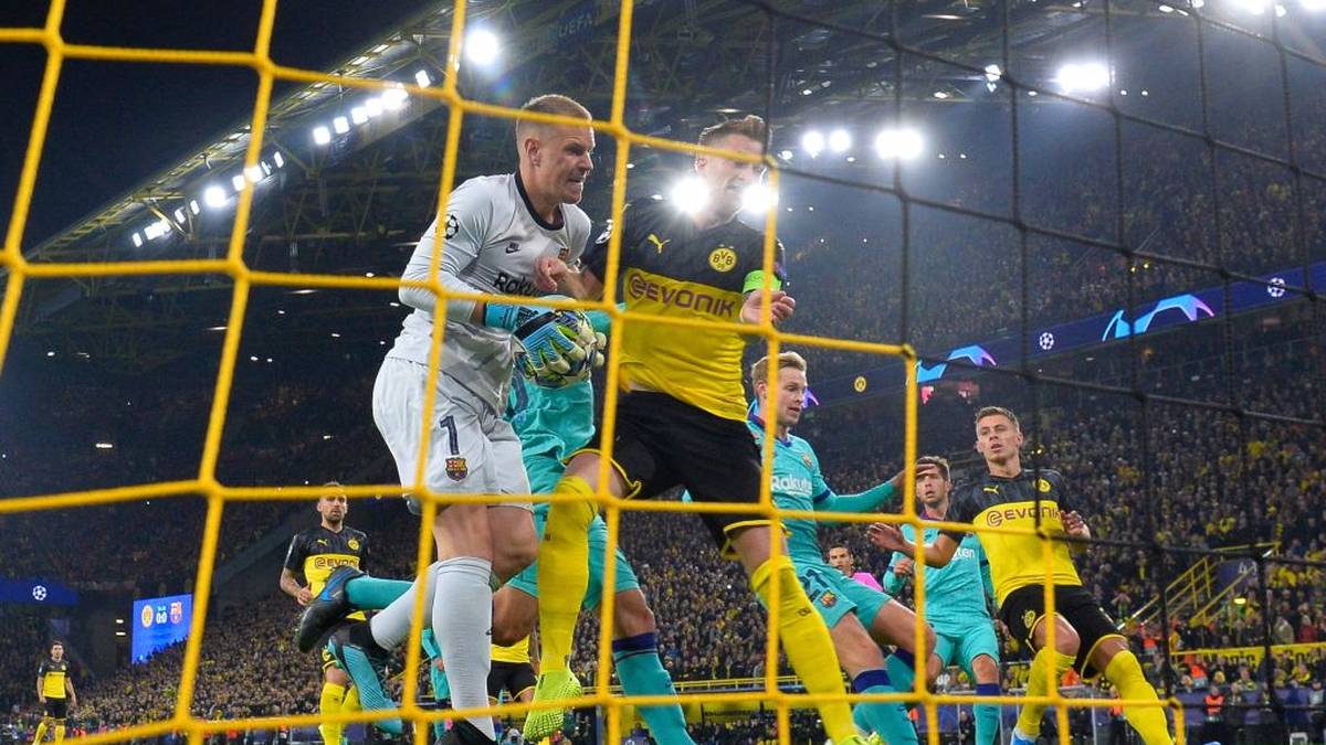Barcelona's German goalkeeper Marc-Andre Ter Stegen (L) holds the ball after saving Dortmund's German forward Marco Reus' penaty during the UEFA Champions League Group F football match Borussia Dortmund v FC Barcelona in Dortmund, western Germany, on September 17, 2019. (Photo by John MACDOUGALL / AFP)        (Photo credit should read JOHN MACDOUGALL/AFP/Getty Images)