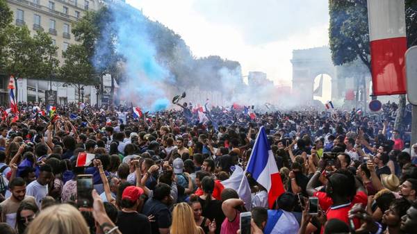 People celebrate France's victory in the Russia 2018 World Cup final football match between France and Croatia, on the Champs-Elysees avenue in Paris on July 15, 2018. (Photo by Zakaria ABDELKAFI / AFP)        (Photo credit should read ZAKARIA ABDELKAFI/AFP via Getty Images)