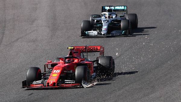 Ferrari's Monegasque driver Charles Leclerc (bottom) drives with a damaged front wing as Mercedes' British driver Lewis Hamilton follows in the Formula One Japanese Grand Prix final at Suzuka on October 13, 2019. (Photo by Behrouz MEHRI / AFP) (Photo by BEHROUZ MEHRI/AFP via Getty Images)
