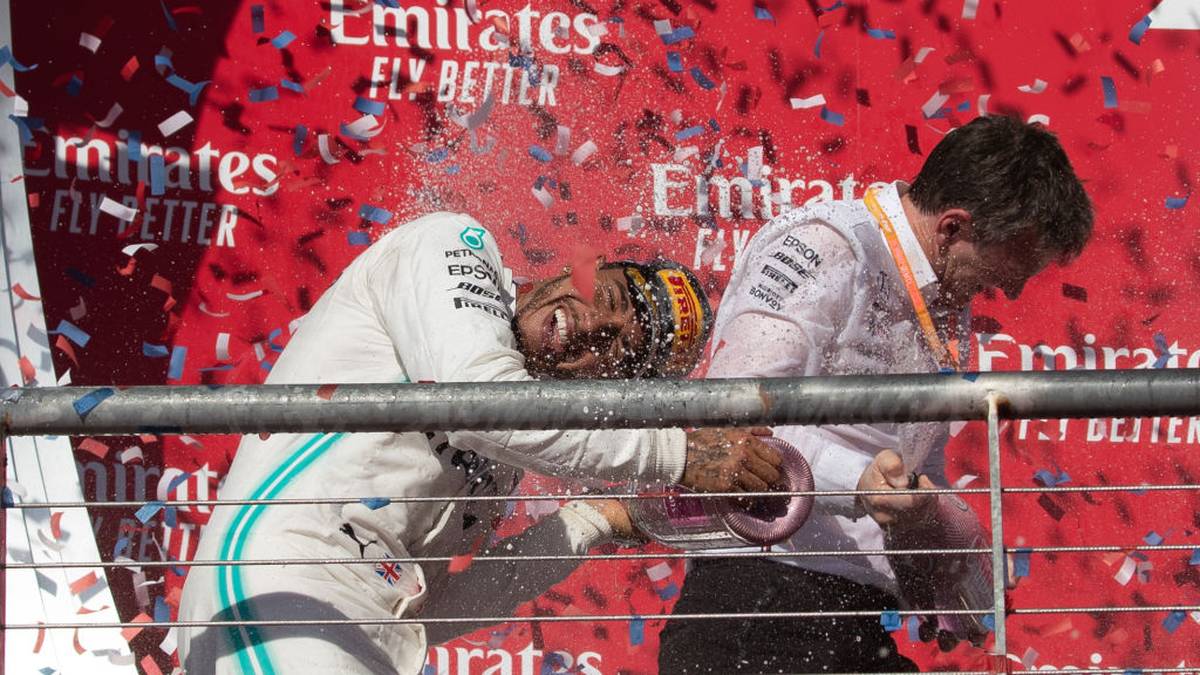 TOPSHOT - Lewis Hamilton (L) of the Mercedes AMG Petronas F1 Team celebrates following the F1 Grand Prix of USA at Circuit of The Americas in Austin, Texas on November 03, 2019. (Photo by SUZANNE CORDEIRO / AFP) (Photo by SUZANNE CORDEIRO/AFP via Getty Images)
