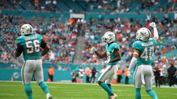 MIAMI, FLORIDA - DECEMBER 22: (L-R) Davon Godchaux #56, Steven Parker #26 an d Nik Needham #40 of the Miami Dolphins celebrate the stop against the Cincinnati Bengals in the second quarter at Hard Rock Stadium on December 22, 2019 in Miami, Florida. (Photo by Mark Brown/Getty Images)