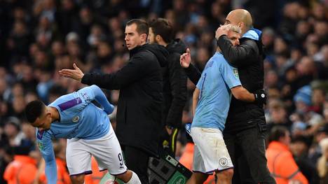 Manchester City's Spanish manager Pep Guardiola (R) hugs Manchester City's Argentinian striker Sergio Aguero as he leaves the pitch after being substituted off for Manchester City's Brazilian striker Gabriel Jesus (L) during the English League Cup semi-final second leg football match between Manchester City and Manchester United at the Etihad Stadium in Manchester, north west England, on January 29, 2020. (Photo by Paul ELLIS / AFP) / RESTRICTED TO EDITORIAL USE. No use with unauthorized audio, video, data, fixture lists, club/league logos or 'live' services. Online in-match use limited to 120 images. An additional 40 images may be used in extra time. No video emulation. Social media in-match use limited to 120 images. An additional 40 images may be used in extra time. No use in betting publications, games or single club/league/player publications. /  (Photo by PAUL ELLIS/AFP via Getty Images)