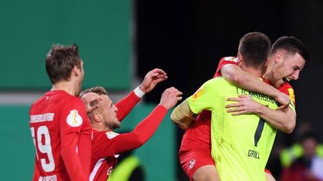 KAISERSLAUTERN, GERMANY - OCTOBER 30: Lennart Grill of 1. FC Kaiserslautern is congratulated after a penalty shoot out by his team mates during the DFB Cup second round match between 1. FC Kaiserslautern and 1. FC Nuernberg at Fritz-Walter-Stadion on October 30, 2019 in Kaiserslautern, Germany. (Photo by Alex Grimm/Bongarts/Getty Images)
