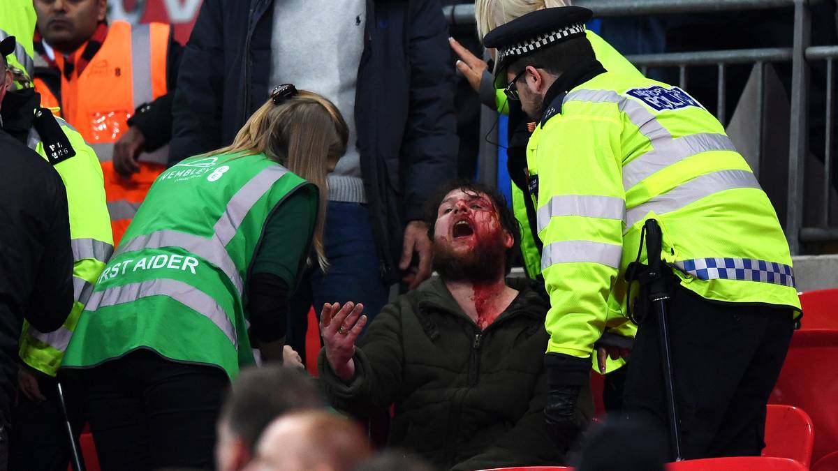 Ein Zuschauer gerät mit Sitznachbarn aneinander, er kann nur mühsam von Ordnern gebändigt werden