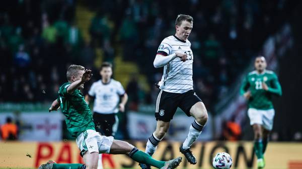 FRANKFURT AM MAIN, GERMANY - NOVEMBER 19: (EDITORS NOTE: Image has been digitally enhanced.) Lukas Klostermann of Germany is tackled by George Saville of Northern Ireland during the UEFA Euro 2020 Qualifier between Germany and Northern Ireland at Commerzbank Arena on November 19, 2019 in Frankfurt am Main, Germany. (Photo by Simon Hofmann/Bongarts/Getty Images)