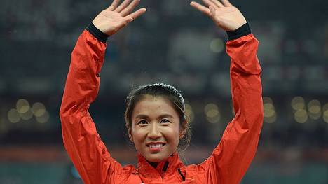China's gold medallist Liu Hong celebrates on the podium during the victory ceremony for the women's 20 kilometres race walk athletics event at the 2015 IAAF World Championships at the "Bird's Nest" National Stadium in Beijing on August 28, 2015.  AFP PHOTO / WANG ZHAO        (Photo credit should read WANG ZHAO/AFP/Getty Images)