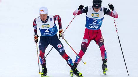 Johannes Lamparter crosses paths with Ryota Yamamoto just before the finish line