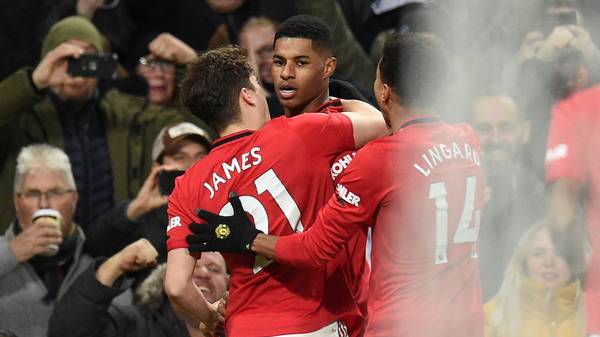 Manchester United's English striker Marcus Rashford (C) celebrates with teammates after scoring their second goal from the penalty spot during the English Premier League football match between Manchester United and Tottenham Hotspur at Old Trafford in Manchester, north west England, on December 4, 2019. (Photo by Oli SCARFF / AFP) / RESTRICTED TO EDITORIAL USE. No use with unauthorized audio, video, data, fixture lists, club/league logos or 'live' services. Online in-match use limited to 120 images. An additional 40 images may be used in extra time. No video emulation. Social media in-match use limited to 120 images. An additional 40 images may be used in extra time. No use in betting publications, games or single club/league/player publications. /  (Photo by OLI SCARFF/AFP via Getty Images)
