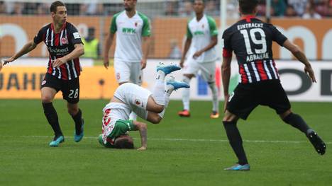 AUGSBURG, GERMANY - SEPTEMBER 14: Philipp Max (C) of FC Augsburg falls during the Bundesliga match between FC Augsburg and Eintracht Frankfurt at WWK-Arena on September 14, 2019 in Augsburg, Germany. (Photo by Alexandra Beier/Bongarts/Getty Images)