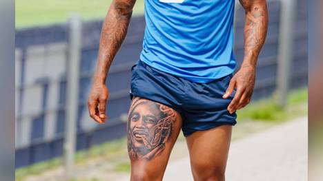 TSG Hoffenheim-Stürmer Gift Orban präsentiert sein neues Tattoo von Bob Marley, der einen Joint raucht.