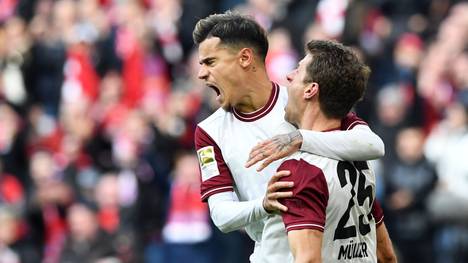 Bayern Munich's striker Thomas Mueller (R) is congratulated by Bayern munich's Brazil midfielder Philippe Coutinho (L) after scoring during the German first division football Bundesliga match between FC Bayern Munich and FC Augsburg in Munich, southern Germany, on March 8, 2020. (Photo by Christof STACHE / AFP) / DFL REGULATIONS PROHIBIT ANY USE OF PHOTOGRAPHS AS IMAGE SEQUENCES AND/OR QUASI-VIDEO (Photo by CHRISTOF STACHE/AFP via Getty Images)