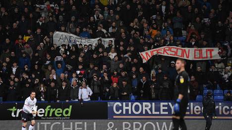 BOLTON, ENGLAND - JANUARY 21:  Andrew Taylor of Bolton removes tennis balls thrown onto the pitch by the home supporters in protest to chairman Ken Anderson prior to kick off during the Sky Bet Championship match between Bolton Wanderers and West Bromwich Albion at University of Bolton Stadium on January 21, 2019 in Bolton, England. (Photo by Gareth Copley/Getty Images)