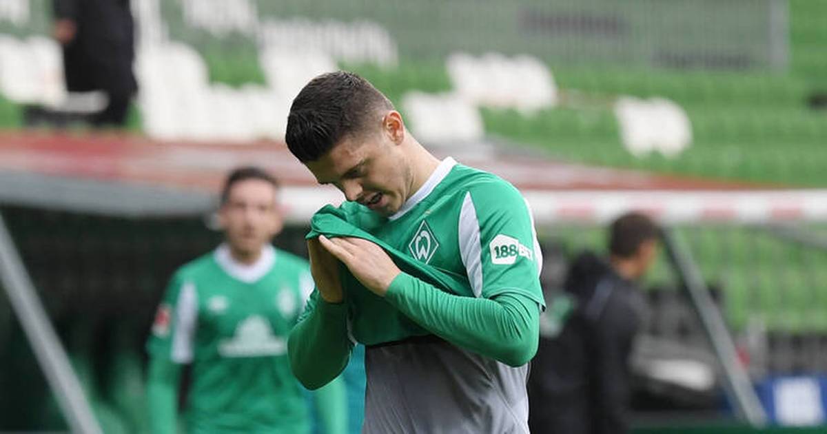 Werder Bremen is in front of a pile of broken glass after relegation