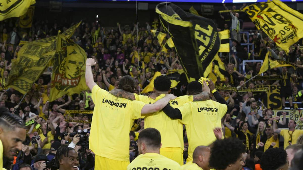 Die BVB-Stars feiern in den Sieger-Shirts mit den mitgereisten Fans