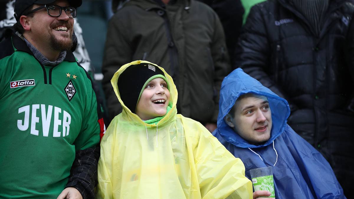 Auch mit den Fans in Mönchengladbach meint es der Wettergott nicht allzu gut - der guten Laune im Borussia-Park tut der Regen allerdings keinen Abbruch