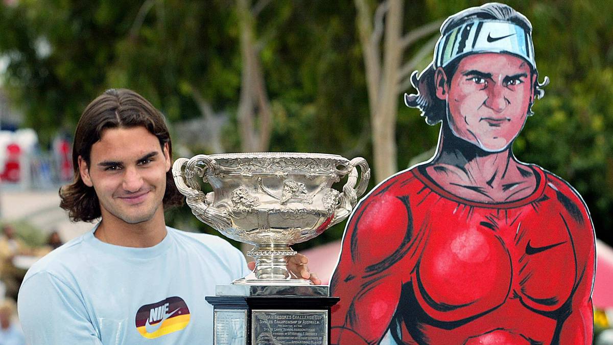 Roger Federer of Switzerland holds up th