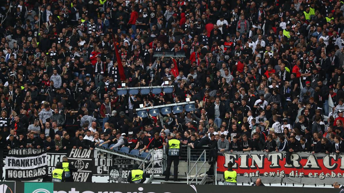 In der Europa League sind Stehplätze offiziell verboten. Doch die Eintracht-Fans wissen sich zu helfen und montieren die Sitzschalen kurzerhand ab