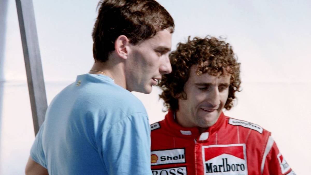 Brazilian Formula One driver Ayrton Senna (L) chats with French Alain Prost at his pits during the Belgian Grand Prix on August 28, 1988. (Photo by - / AFP)        (Photo credit should read -/AFP/Getty Images)