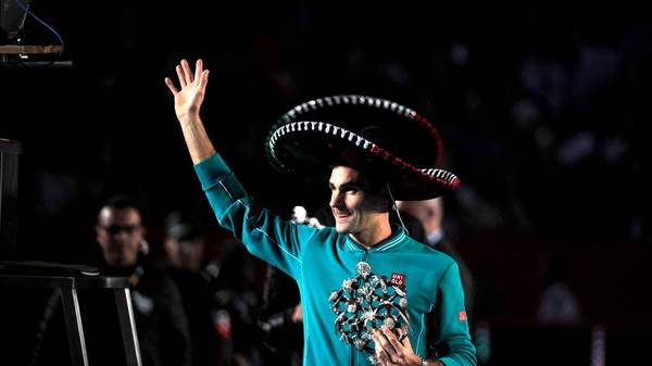Switzerland's Roger Federer holds a Mexican hat and a trophy at the exhibition tennis singles match against Germany's Alexander Zverev in Mexico City, on November 23, 2019. (Photo by CLAUDIO CRUZ / AFP) (Photo by CLAUDIO CRUZ/AFP via Getty Images)