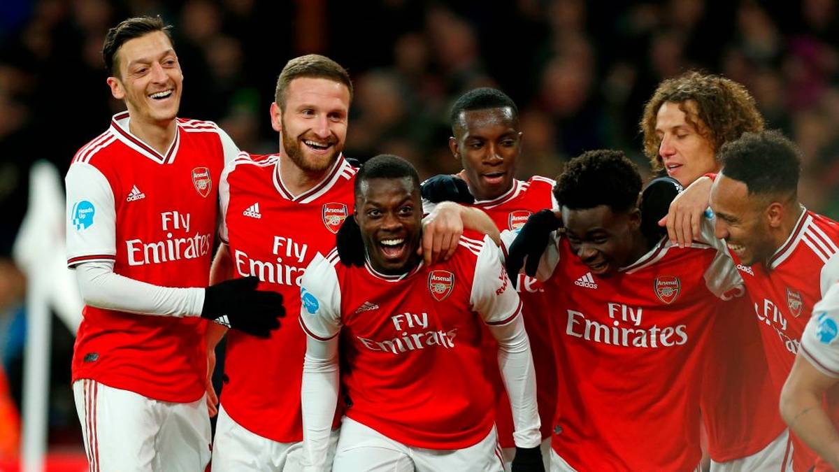 Arsenal's French-born Ivorian midfielder Nicolas Pepe (C) celebrates with teammates after scoring their second goal during the English Premier League football match between Arsenal and Newcastle United at the Emirates Stadium in London on February 16, 2020. (Photo by Ian KINGTON / AFP) / RESTRICTED TO EDITORIAL USE. No use with unauthorized audio, video, data, fixture lists, club/league logos or 'live' services. Online in-match use limited to 120 images. An additional 40 images may be used in extra time. No video emulation. Social media in-match use limited to 120 images. An additional 40 images may be used in extra time. No use in betting publications, games or single club/league/player publications. /  (Photo by IAN KINGTON/AFP via Getty Images)