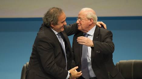 Senes Erzik wird von UEFA-Präsident Michel Platini umarmt