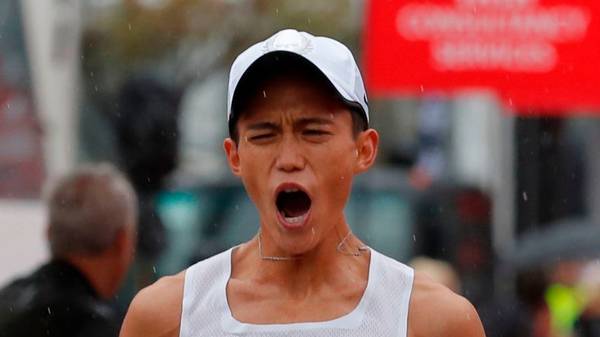 Suguru Osako of Japan reacts after finishing third in the Chicago Marathon in Chicago, on October 7, 2018. - British athletics star Mo Farah won the Chicago Marathon men's title on Sunday in an unofficial time of 2hr 5min 11sec, shattering a European record with a spectacular finishing surge. The world and Olympic 5,000 and 10,000-meter champion became the first British man to capture the event since Paul Evans in 1996.The 35-year-old Somalia-born Briton claimed the biggest victory since he turned his attention to the distance a year ago to defeat Ethiopia's Mosinet Geremew by 13 seconds with Japan's Suguru Osako third in 2:05:50. (Photo by JIM YOUNG / AFP) / The erroneous mention appearing in the metadata of this photo by JIM YOUNG has been modified in AFP systems in the following manner: [Suguru Osako of Japan] instead of [Suguru Osaka of Japan]. Please immediately remove the erroneous mention from all your online services and delete it from your servers. If you have been authorized by AFP to distribute it to third parties, please ensure that the same actions are carried out by them. Failure to promptly comply with these instructions will entail liability on your part for any continued or post notification usage. Therefore we thank you very much for all your attention and prompt action. We are sorry for the inconvenience this notification may cause and remain at your disposal for any further information you may require.        (Photo credit should read JIM YOUNG/AFP/Getty Images)