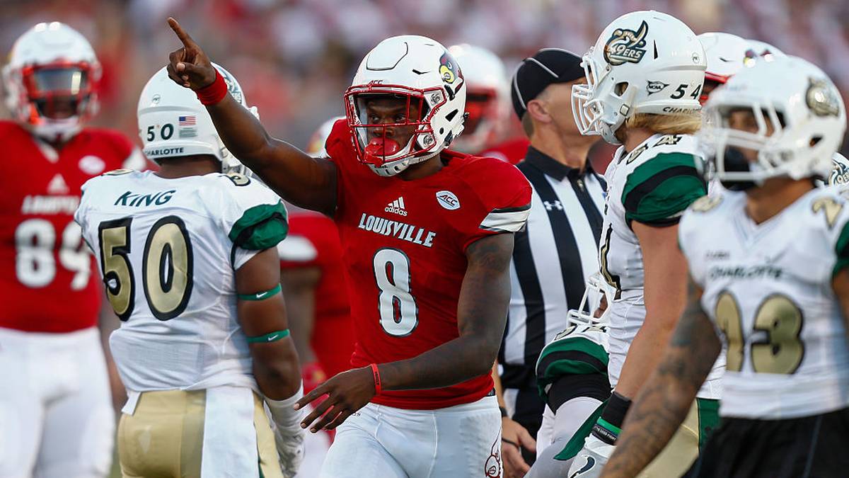 Lamar Jackson of the Louisville Cardinals signals a first down during the game against the Charlotte 49ers