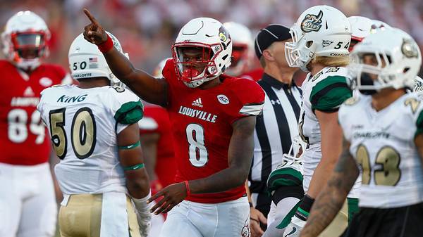 Lamar Jackson of the Louisville Cardinals signals a first down during the game against the Charlotte 49ers