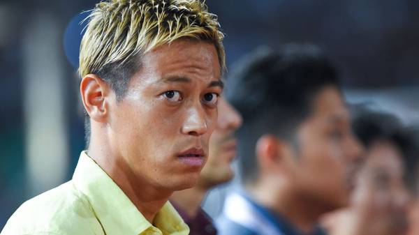 Cambodia's national football team manager Keisuke Honda (L) looks on during the 2022 World Cup Asian zone 2nd round qualifying football match between Cambodia and Iraq at Olympic stadium in Phnom Penh on October 15, 2019. (Photo by TANG CHHIN Sothy / AFP) (Photo by TANG CHHIN SOTHY/AFP via Getty Images)