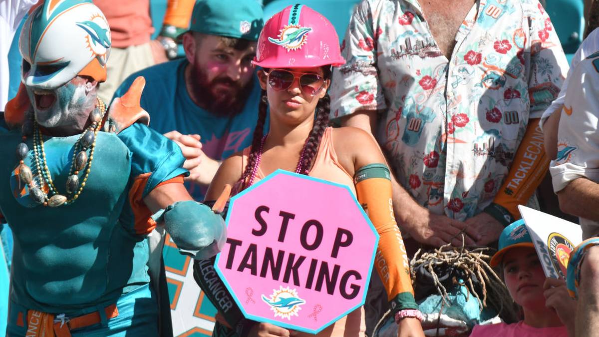 MIAMI, FL - OCTOBER 13: A Miami Dolphins fan holds a sign that reads "Stop Tanking" during the game against the Washington Redskins at Hard Rock Stadium on October 13, 2019 in Miami, Florida. (Photo by Eric Espada/Getty Images)