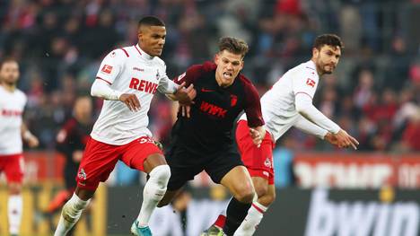 COLOGNE, GERMANY - NOVEMBER 30:  Florian Niederlechner of FC Augsburg is challenged by Florian Kainz of FC Koeln during the Bundesliga match between 1. FC Koeln and FC Augsburg at RheinEnergieStadion on November 30, 2019 in Cologne, Germany. (Photo by Lars Baron/Bongarts/Getty Images)