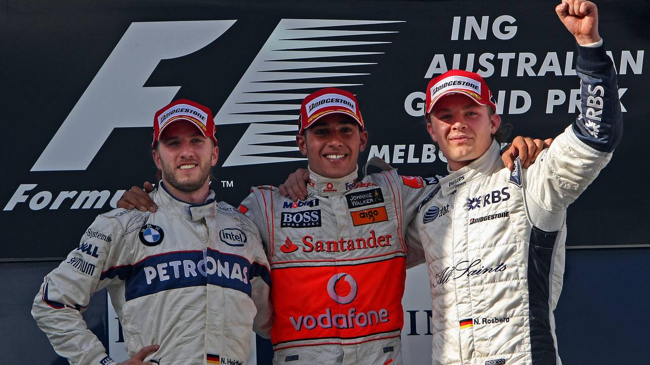 Britain's Lewis Hamilton (C) shares the