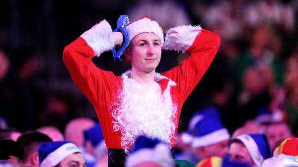 LONDON, ENGLAND - DECEMBER 23: A fan in fancy dress reacts as they watch the Third Round match between Jeffrey de Zwaan of The Netherlands and Dave Chisnall of England during Day Eleven of the 2020 William Hill World Darts Championship at Alexandra Palace on December 23, 2019 in London, England. (Photo by Alex Burstow/Getty Images)
