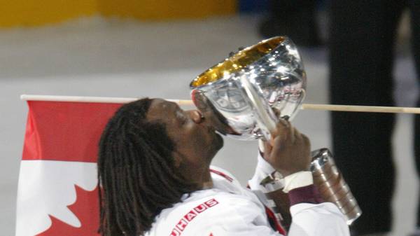Canada's Anson Carter kisses the trophy 