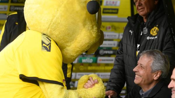 Mascot Emma shakes hands with Dortmund's Swiss coach Lucien Favre prior the German first division Bundesliga football match between Borussia Dortmund and VfL Wolfsburg on November 2, 2019 in Dortmund, western Germany. (Photo by INA FASSBENDER / AFP) / DFL REGULATIONS PROHIBIT ANY USE OF PHOTOGRAPHS AS IMAGE SEQUENCES AND/OR QUASI-VIDEO (Photo by INA FASSBENDER/AFP via Getty Images)