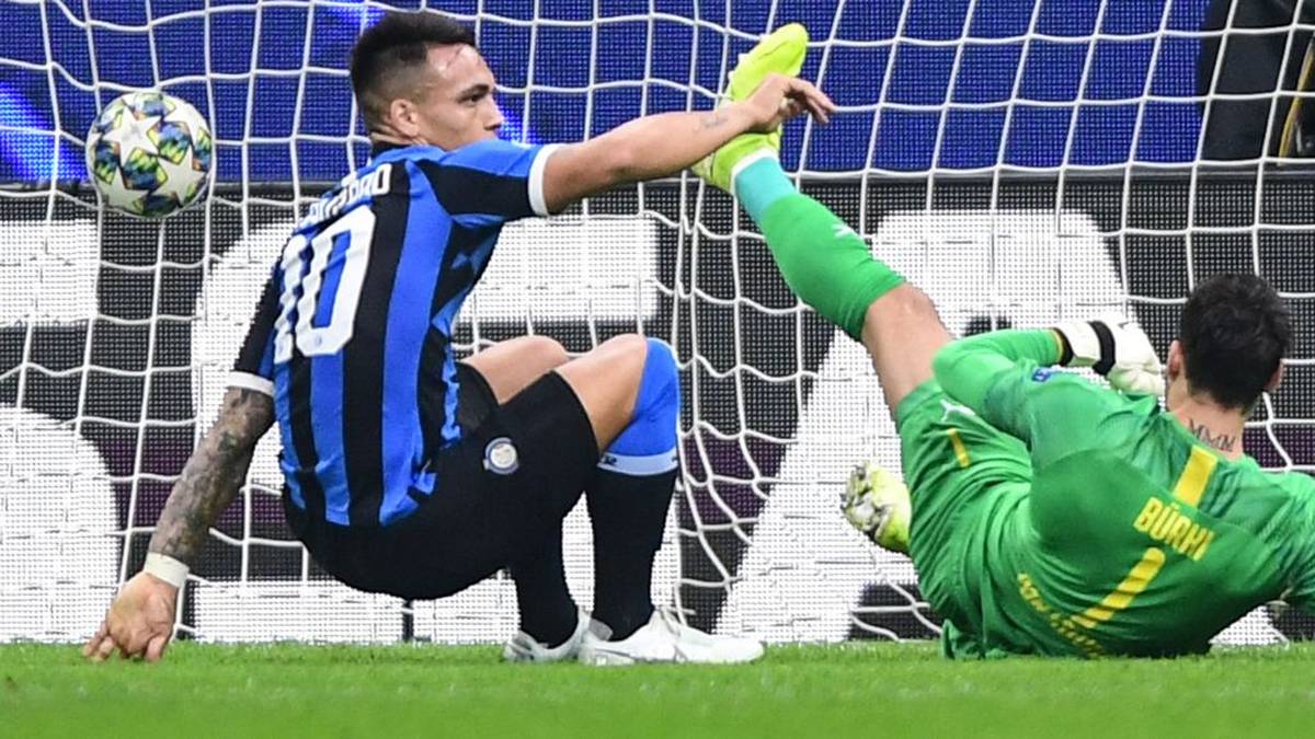 Inter Milan's Argentinian forward Lautaro Martinez (L) gets back up after opening the scoring past Dortmund's Swiss goalkeeper Roman Buerki (R) during the UEFA Champions League Group F football match Inter Milan vs Borussia Dortmund on October 23, 2019 at the San Siro stadium in Milan. (Photo by Miguel MEDINA / AFP) (Photo by MIGUEL MEDINA/AFP via Getty Images)