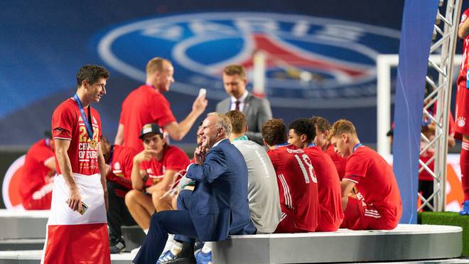 Bayern coach Karl-Heinz Rummenigge joins players after winning the Champions League
