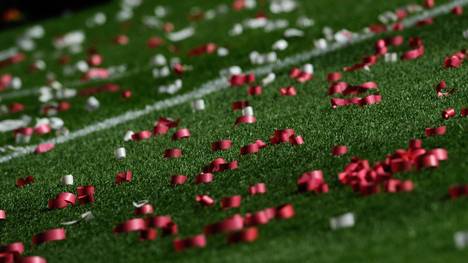 Colored confetti lies on the pitch after