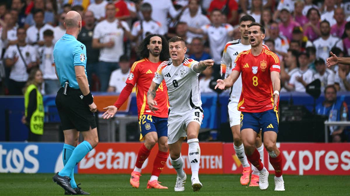 Toni Kroos beschwert sich bei Schiedsrichter Anthony Taylor - im Hintergrund ist der Spanier Marc Cucurella (Nr. 24) zu sehen