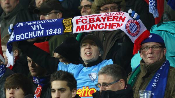 BOCHUM, GERMANY - DECEMBER 20: A fan of Bochum holds up a scarf during the DFB Cup round of sixteen match between VfL Bochum and FC Bayern Muenchen at Rewirpower Stadium on December 20, 2011 in Bochum, Germany. (Photo by Christof Koepsel/Bongarts/Getty Images)