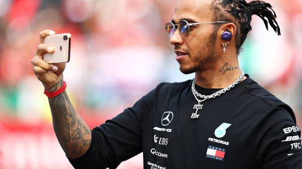 MEXICO CITY, MEXICO - OCTOBER 27: Lewis Hamilton of Great Britain and Mercedes GP takes a video on the drivers parade before the F1 Grand Prix of Mexico at Autodromo Hermanos Rodriguez on October 27, 2019 in Mexico City, Mexico. (Photo by Mark Thompson/Getty Images)
