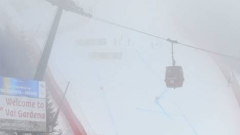 Race marshalls stand in the middle of the slope after the FIS Alpine World Cup Men Super G was interrupted due to bad weather conditions on December 20, 2019 in Val Gardena - Groeden, Italian Alps. (Photo by Alberto PIZZOLI / AFP) (Photo by ALBERTO PIZZOLI/AFP via Getty Images)